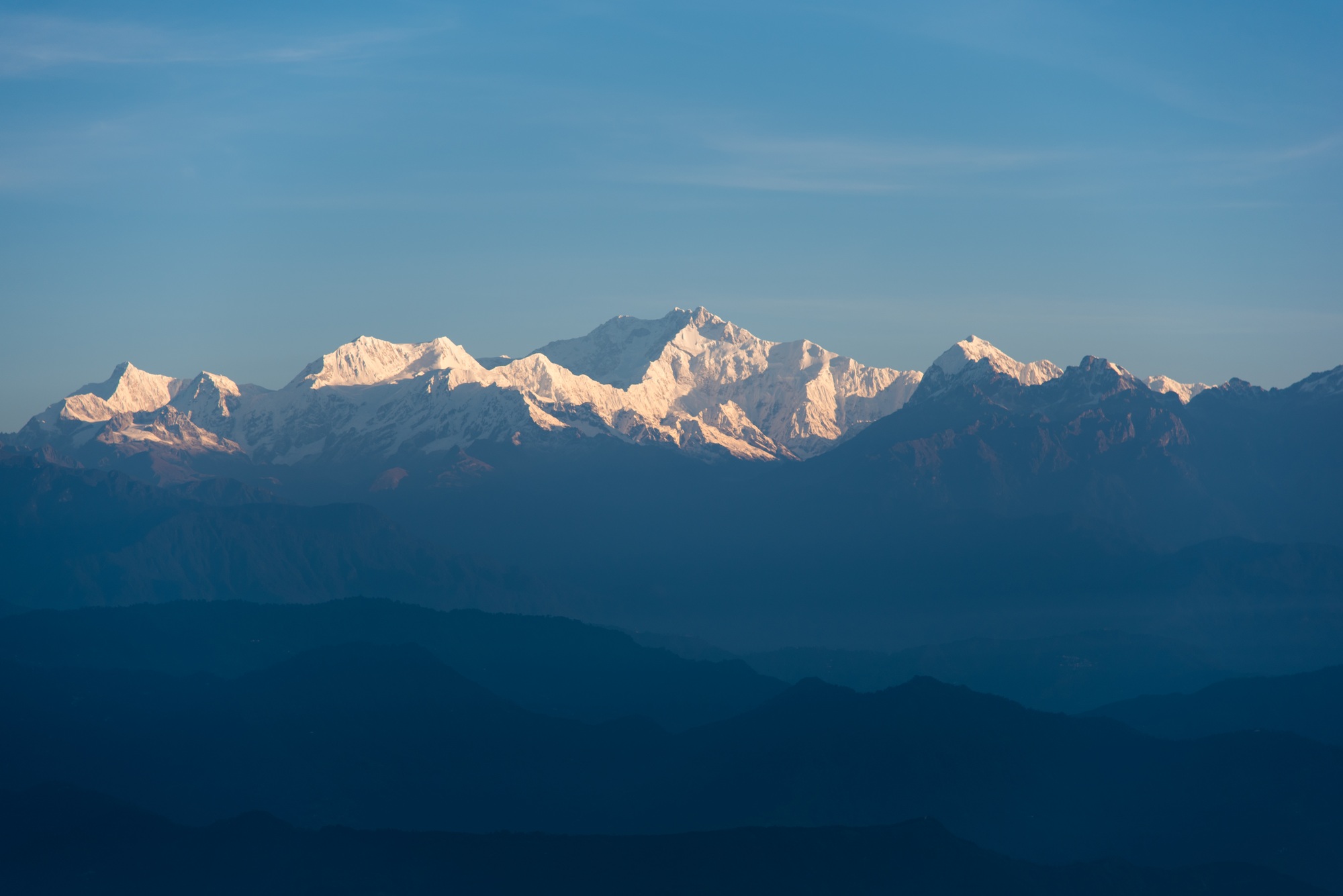 Snow capped mountain peaks in the morning light.